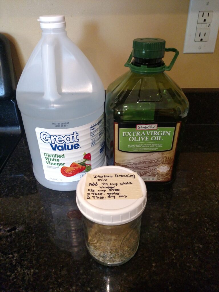 homemade italian dressing mix, vinegar and evoo on counter