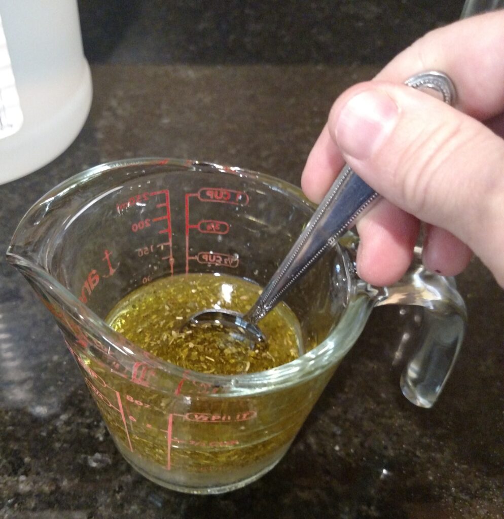 stirring dry ingredients with olive oil and vinegar