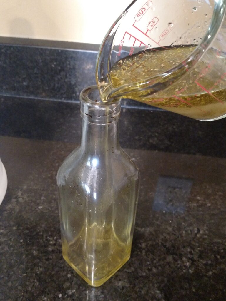 pouring Homemade Italian dressing into a bottle