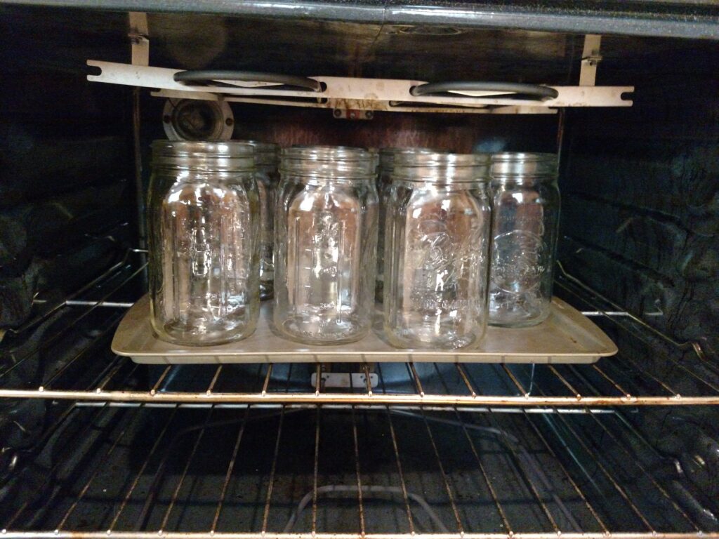 canning jars warming in oven