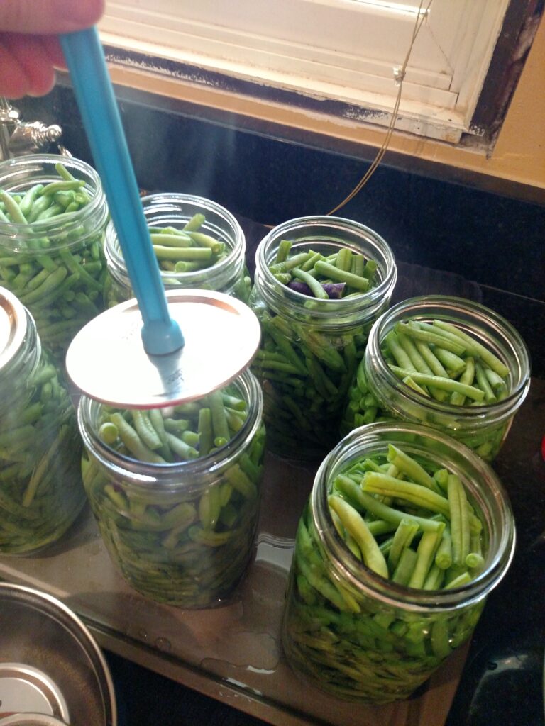 putting the lid on the canning jar