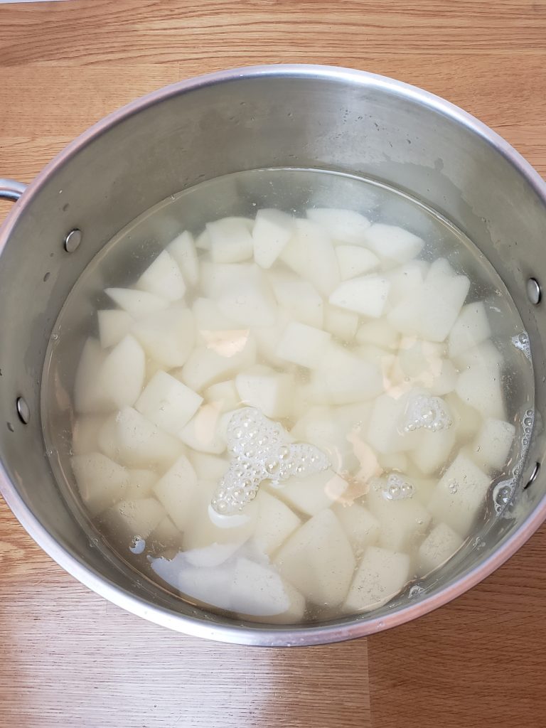 water and cubed potatoes in saucepan ready to cook