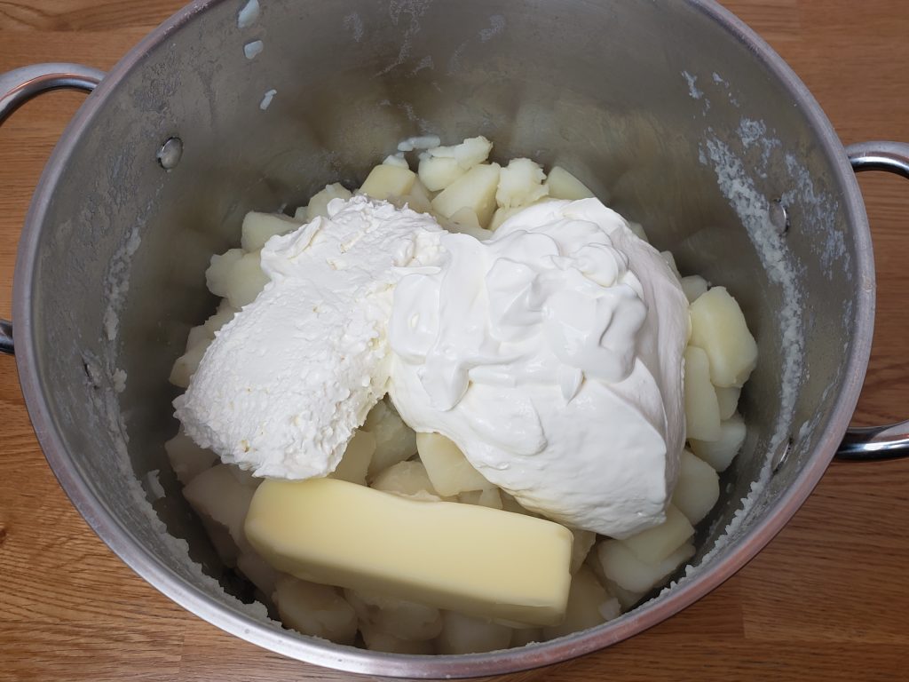 sour cream, cream cheese and butter added to pan with potatoes