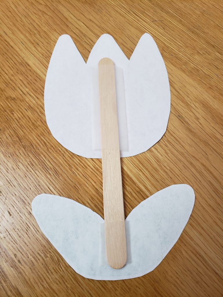 popsicle stick taped onto the flower