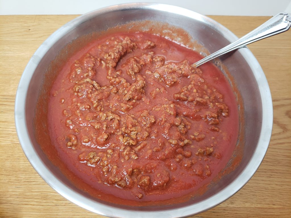 tomato sauce and meat in metal bowl