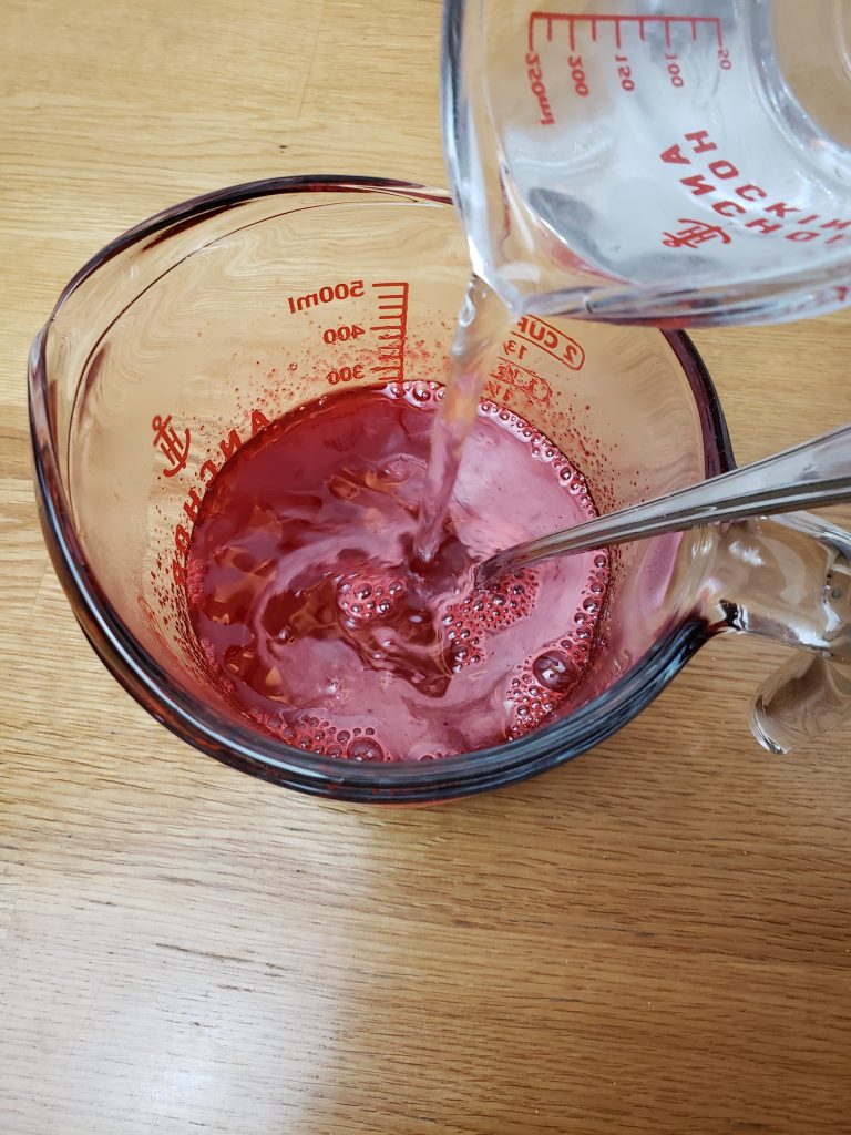 adding water to red jell-o