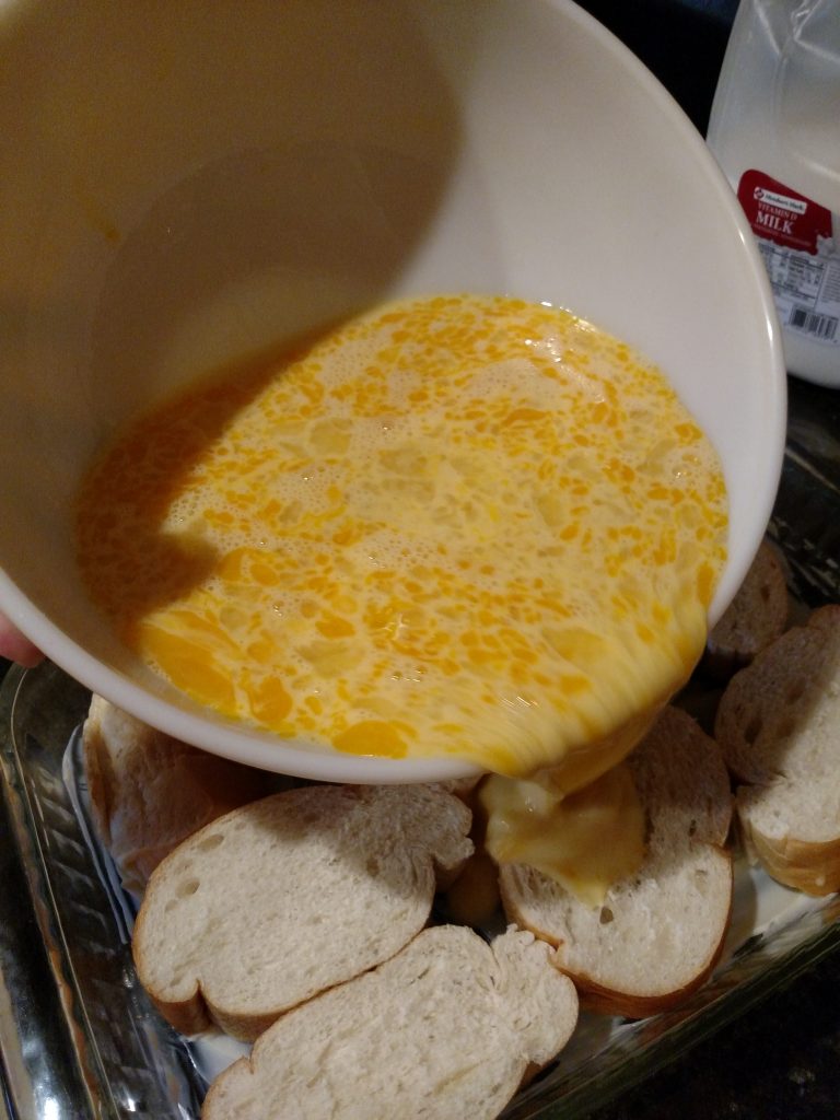 pouring egg mixture over bread slices