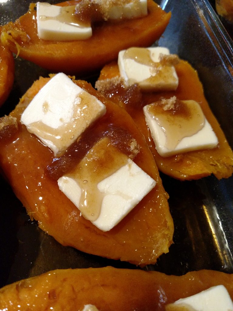 candied sweet potatoes in pan with butter, brown sugar and syrup