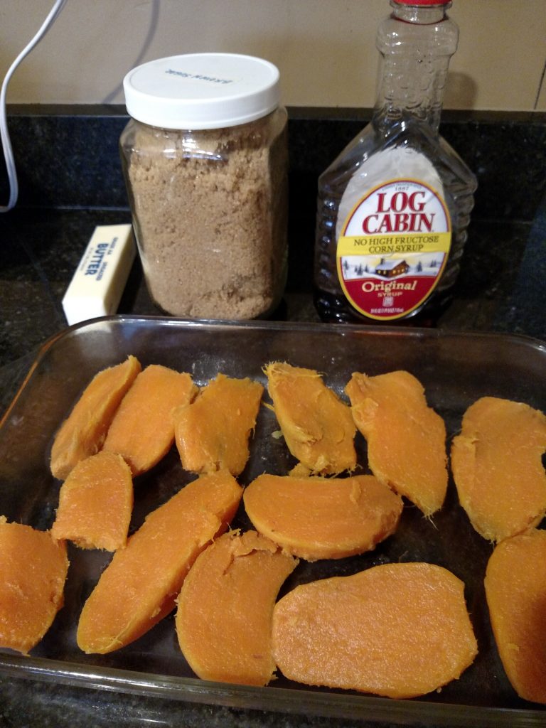 sweet potatoes cut in half and in pan