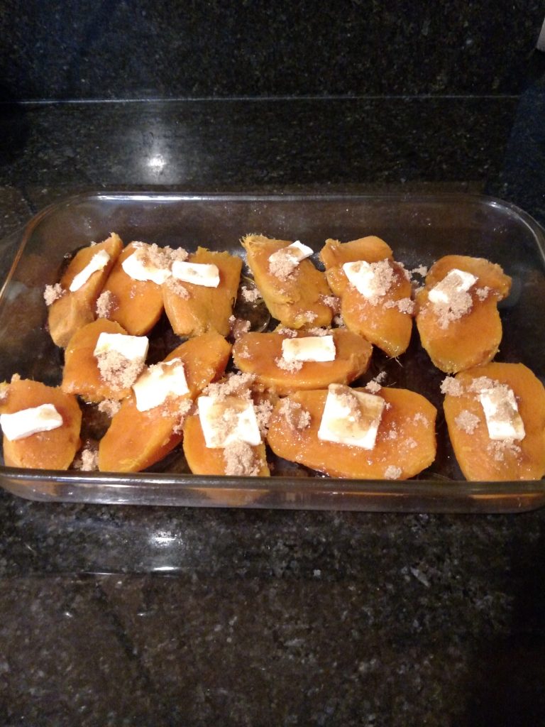 sweet potatoes in pan with butter, brown sugar and syrup