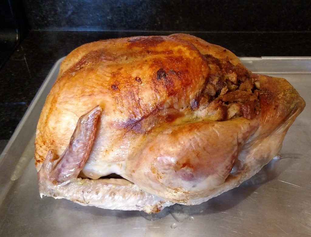 Beautiful cooked turkey on cutting sheet