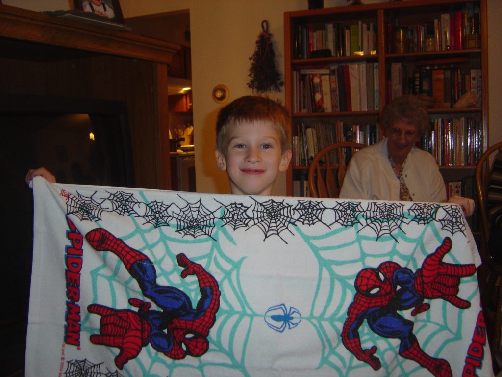 young boy with spider man bath towel