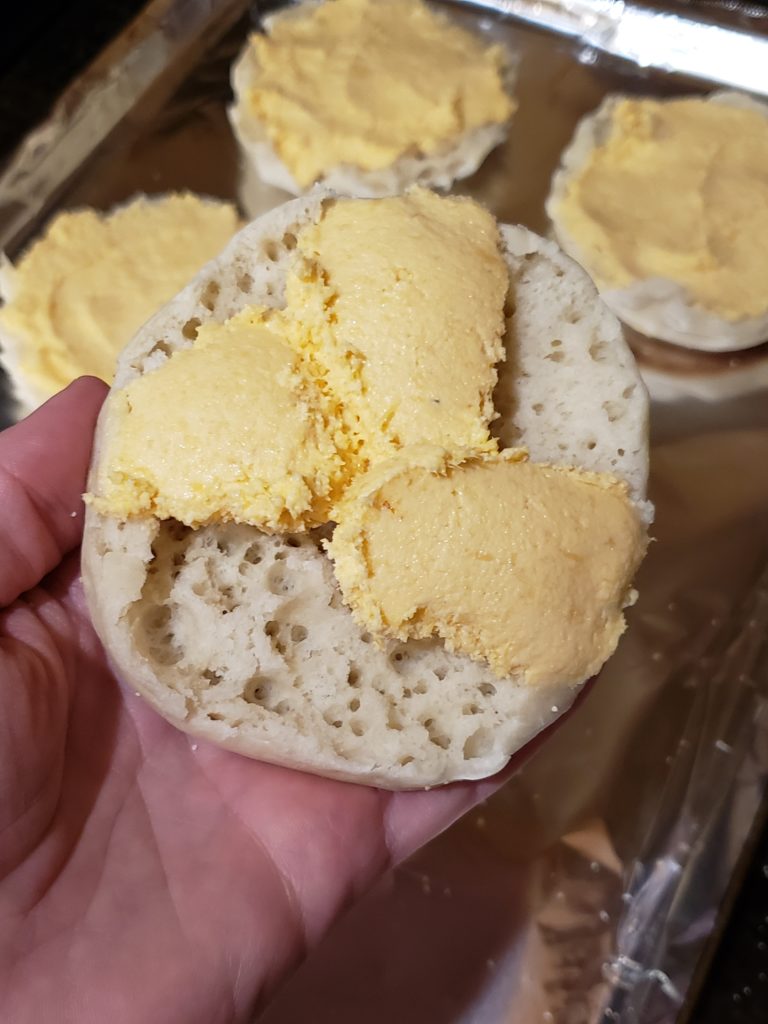 showing how much filling to put on muffin for Cheesy Crabmeat Appetizers