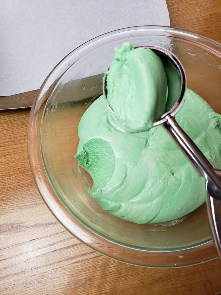 scooping green cookie batter