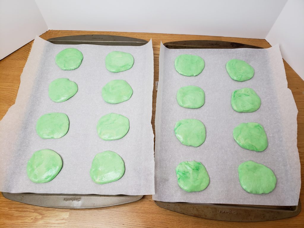 green cookies on cookie sheet unbaked