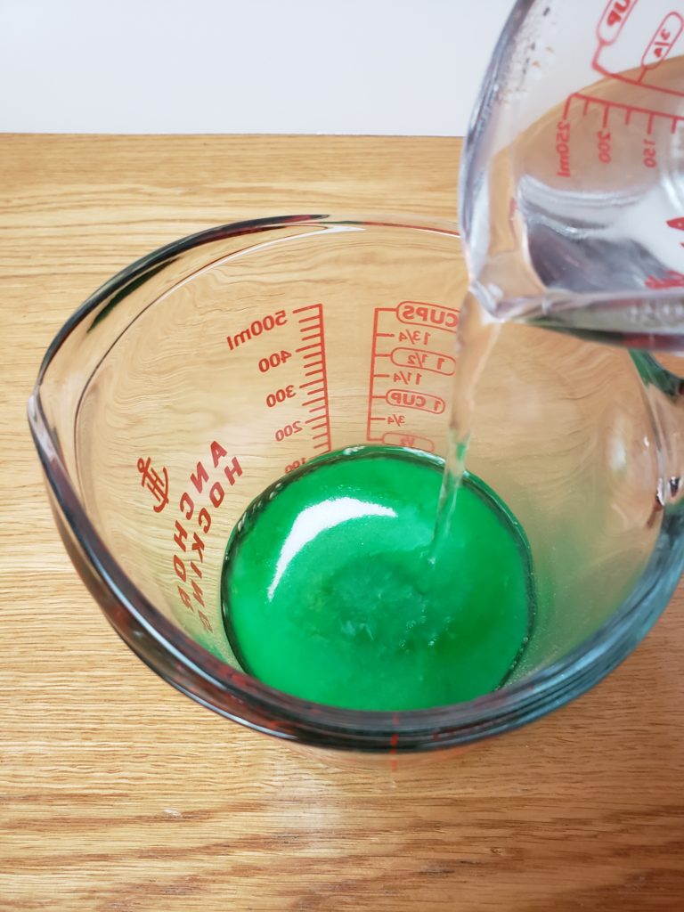 pouring water into green jello