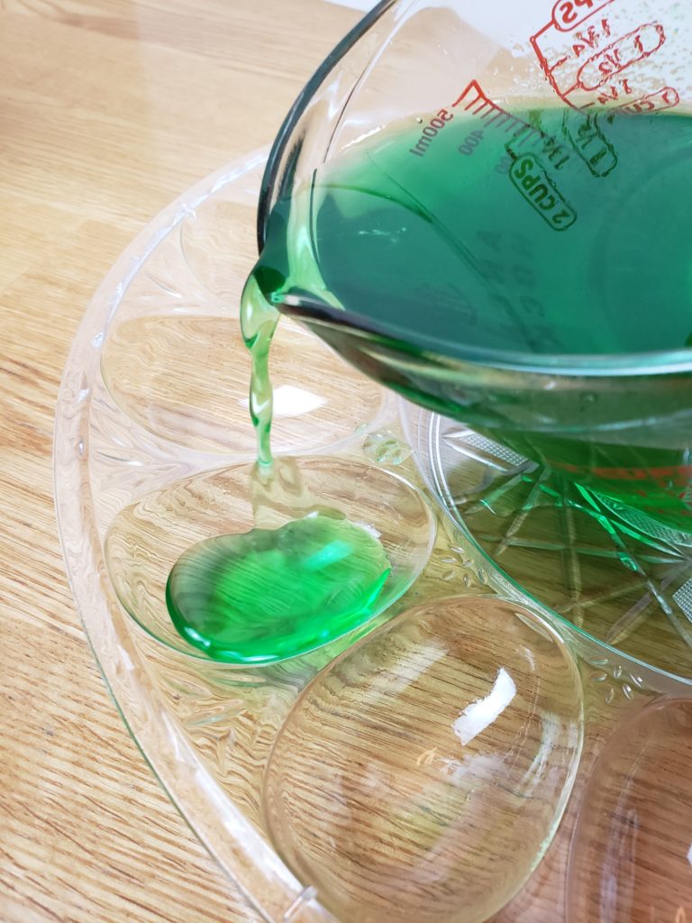 pouring green jello in deviled egg mold