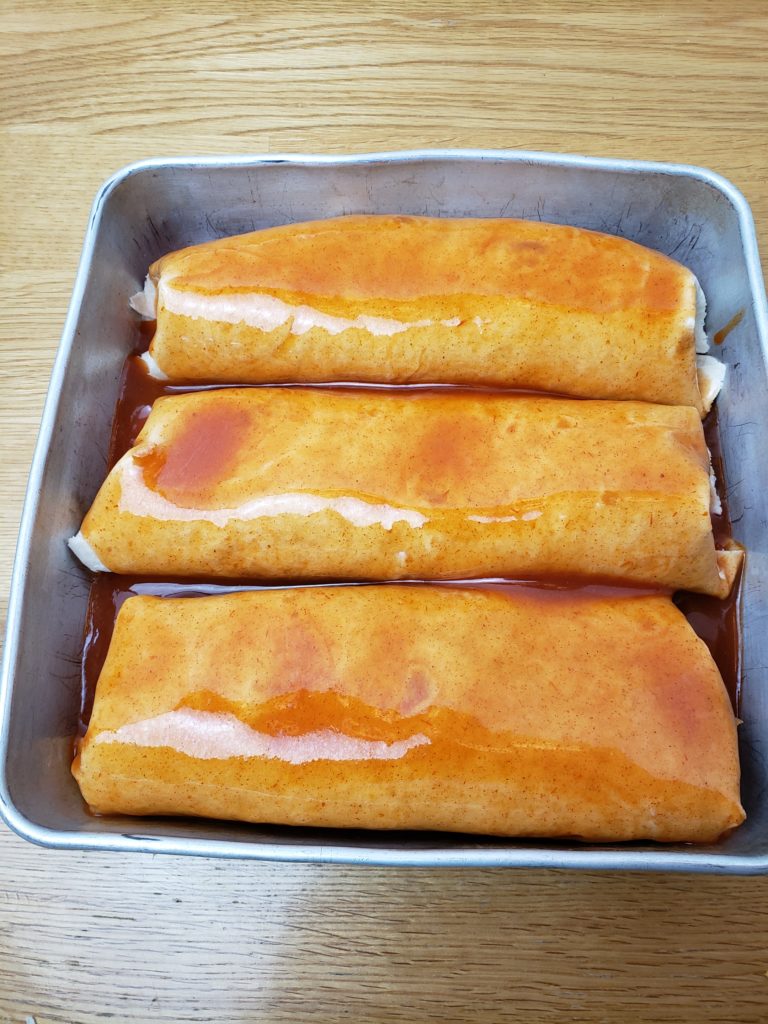 Quick Easy Beef Enchiladas in baking pan before adding cheese