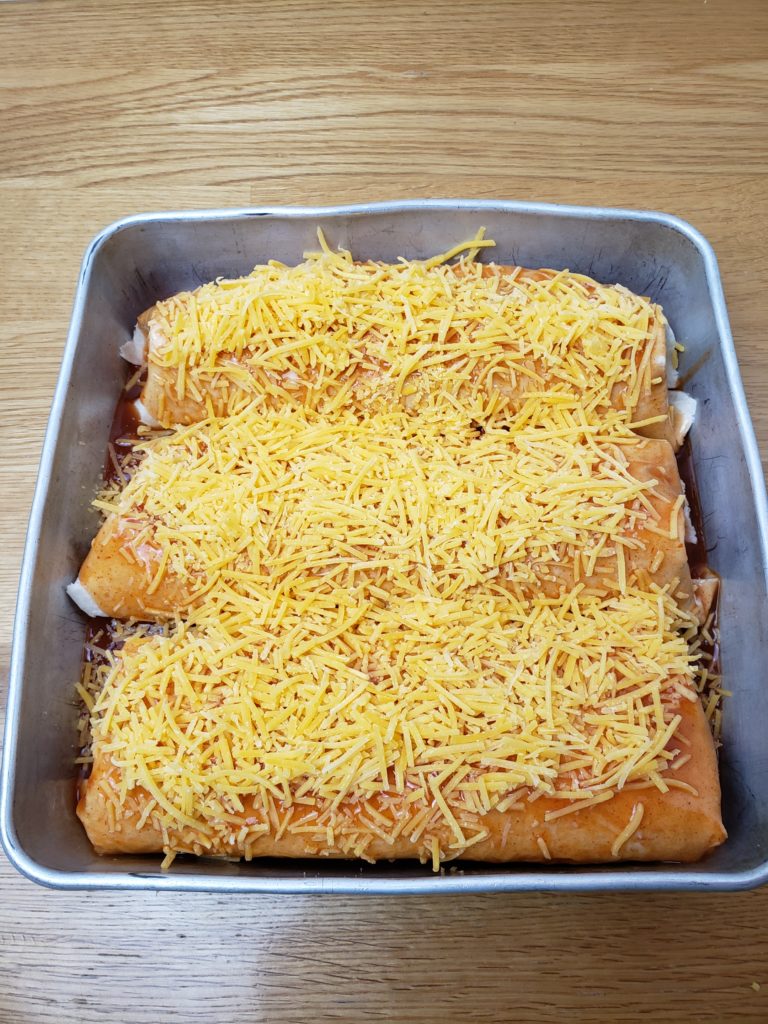 Quick Easy Beef Enchiladas in baking pan ready to bak