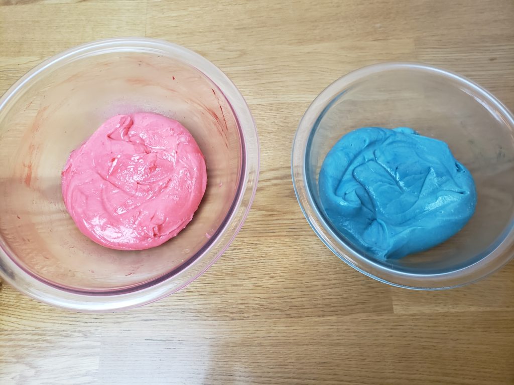 one bowl of red cookie dough and one bowl of blue