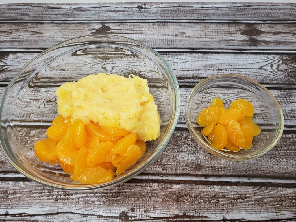 oranges and pineapple set aside in two bowls