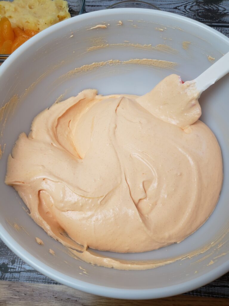 stirring Cool Whip and Jell-O mix into pudding