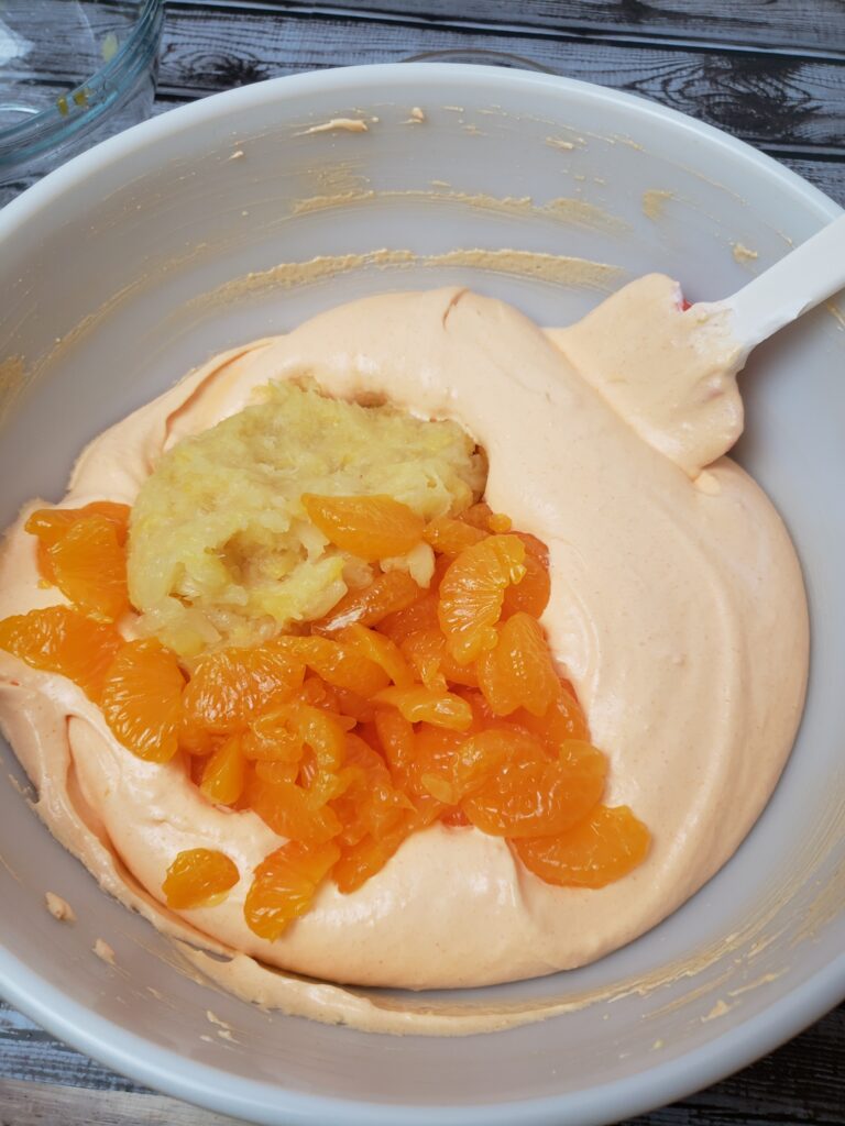 oranges and pineapple added to pudding and Jell-O mixture