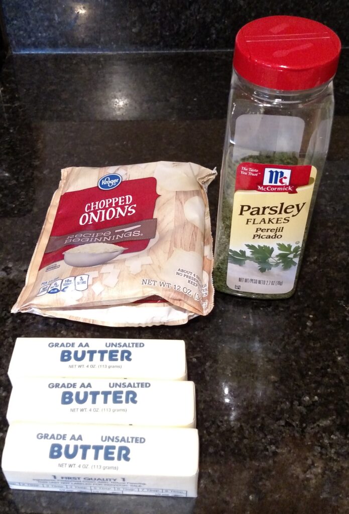 bag of frozen chopped onions, parsley flakes and 3 sticks of butter on counter