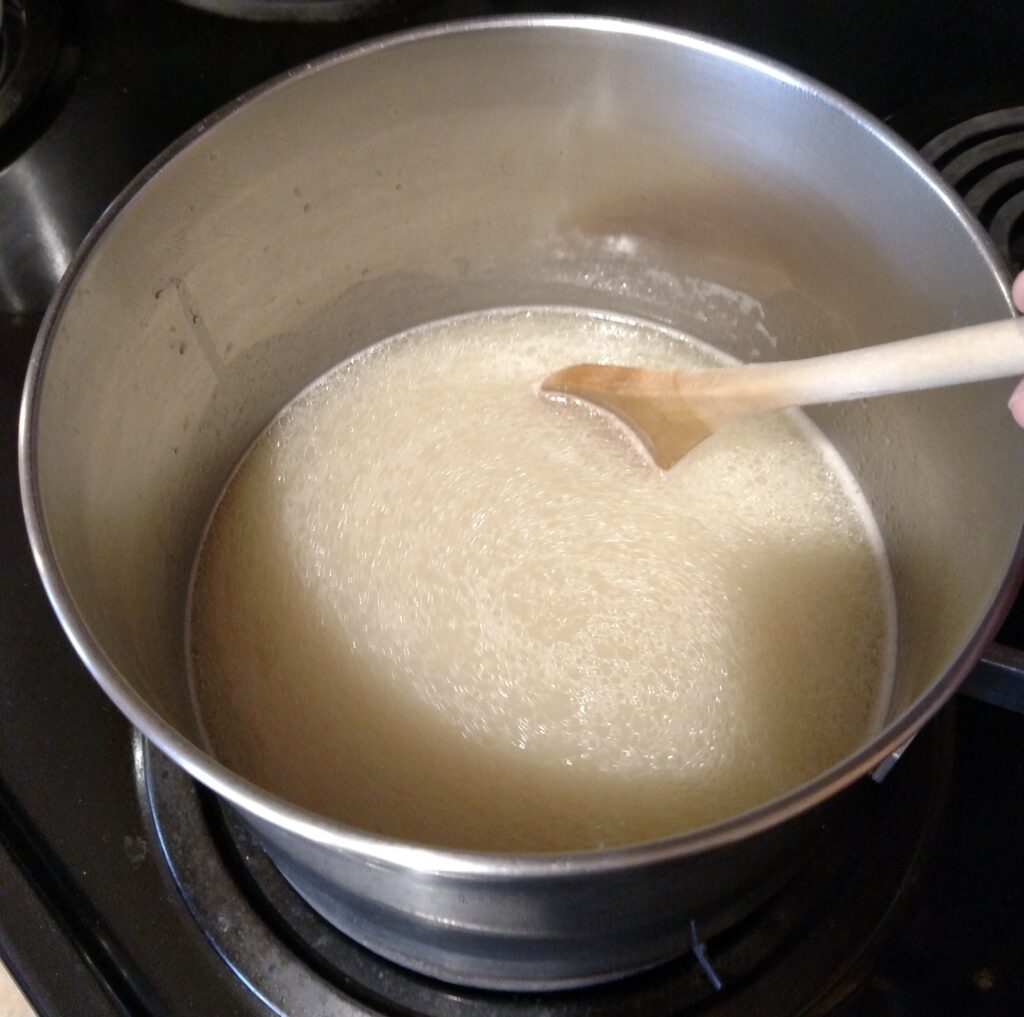 stirring gravy in saucepan on stove