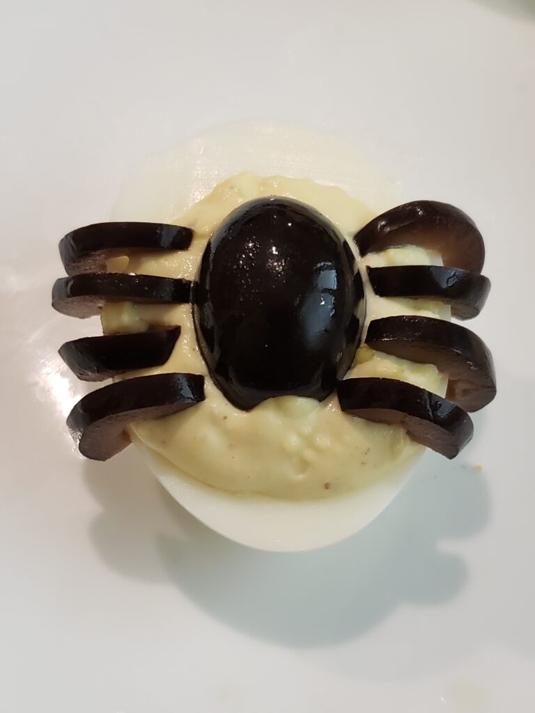 black olive legs put on deviled egg.