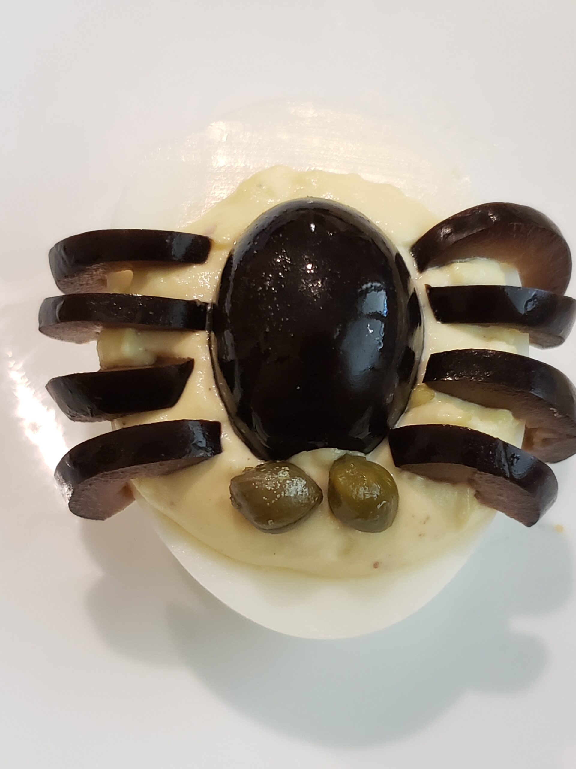capers added to deviled egg as spider eyes.
