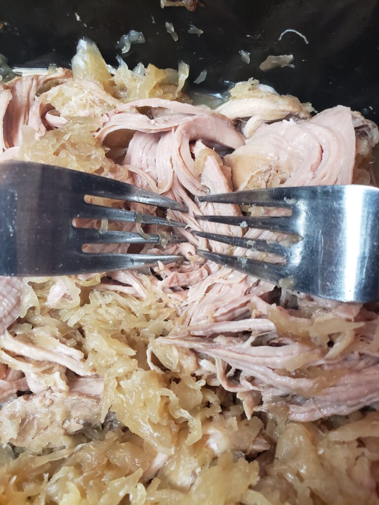 shredding the pork with two forks