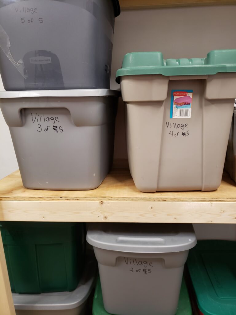 village bins piled on storage shelves