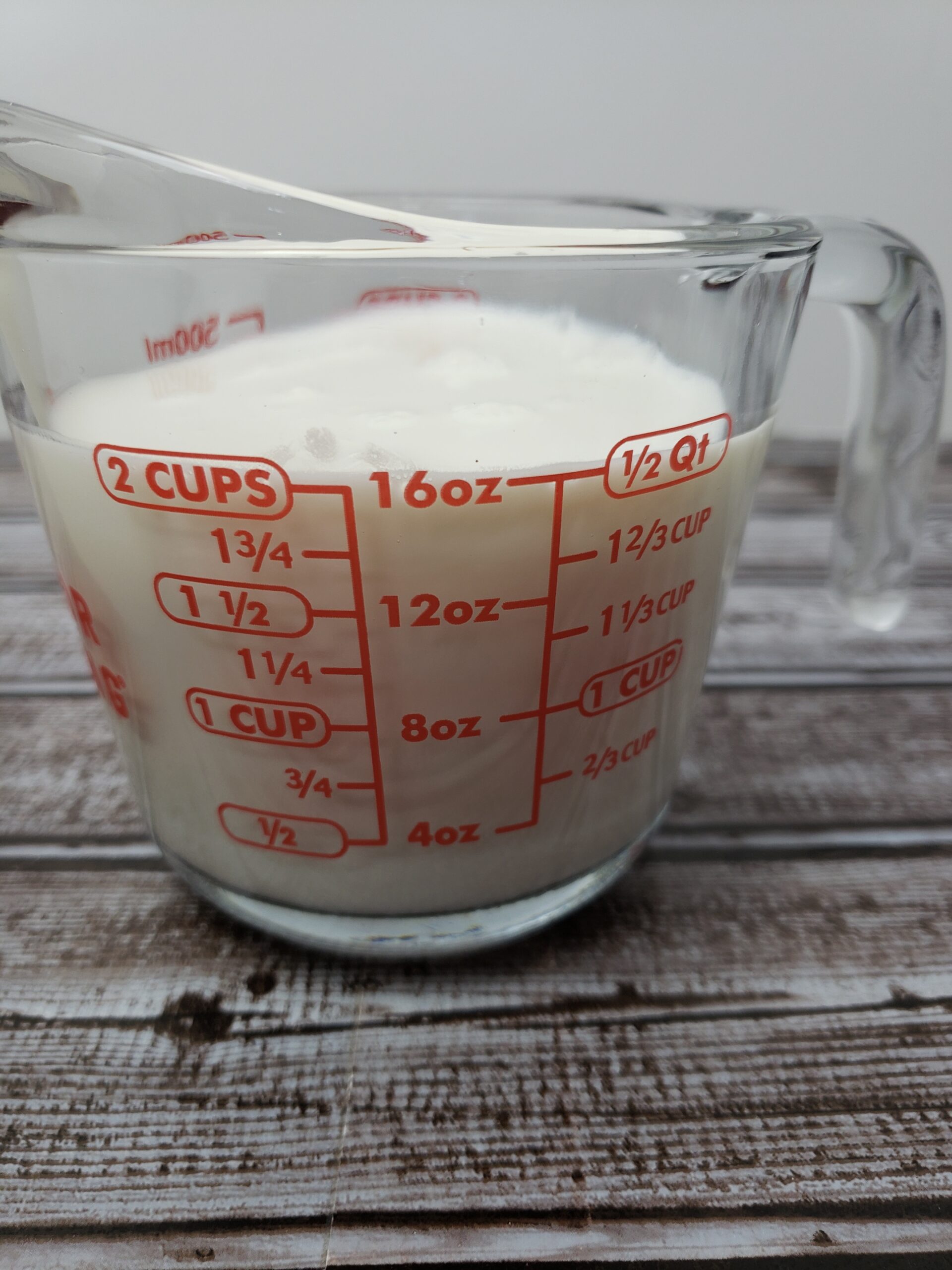 Buttermilk in 2 cup measuring cup.
