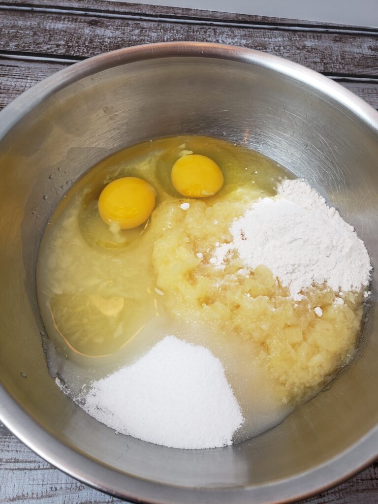 pineapple, eggs, flour and sugar in mixing bowl