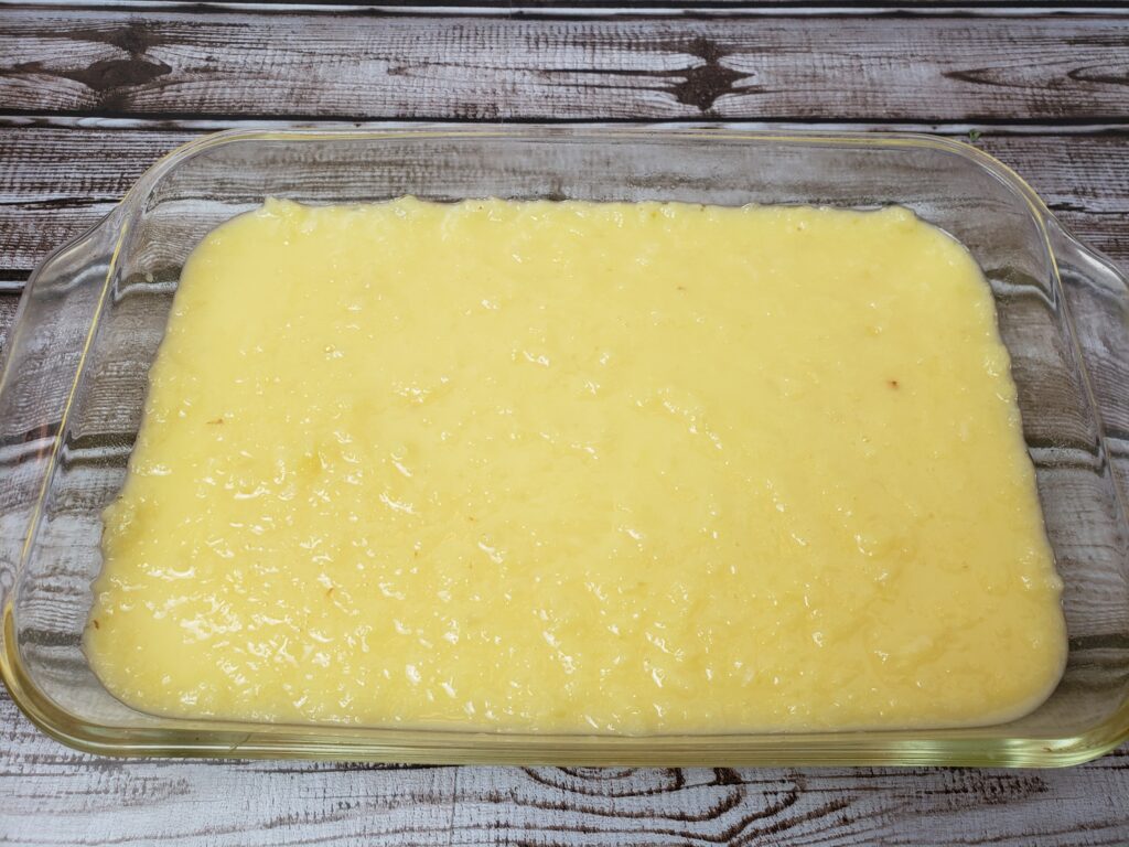 pineapple, eggs, flour and sugar mixture spread into glass baking pan