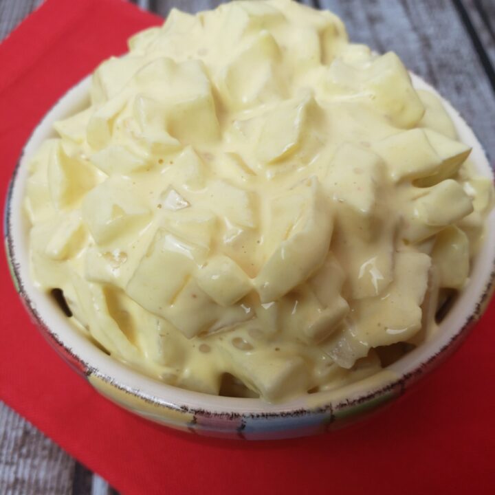Onion Relish in serving dish on red napkin.