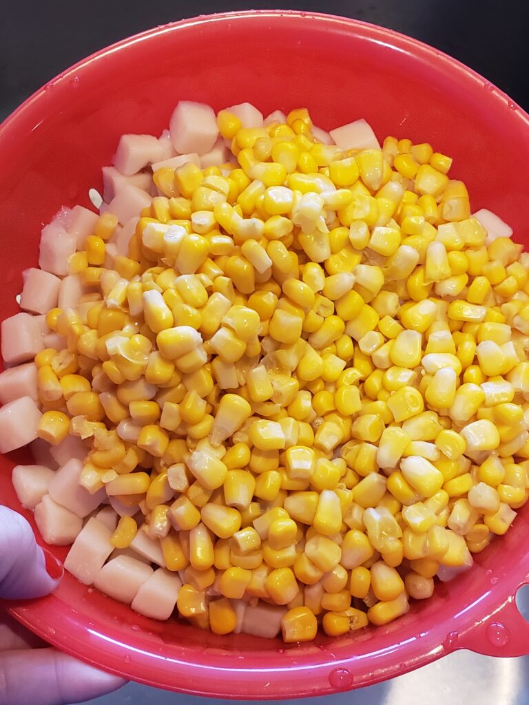 corn and potatoes in strainer