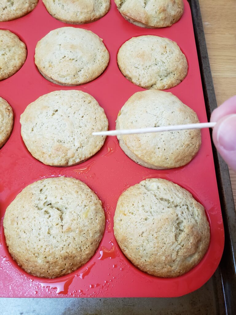 testing muffin with a toothpick