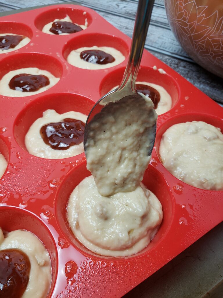 adding a little more batter on top of jelly.