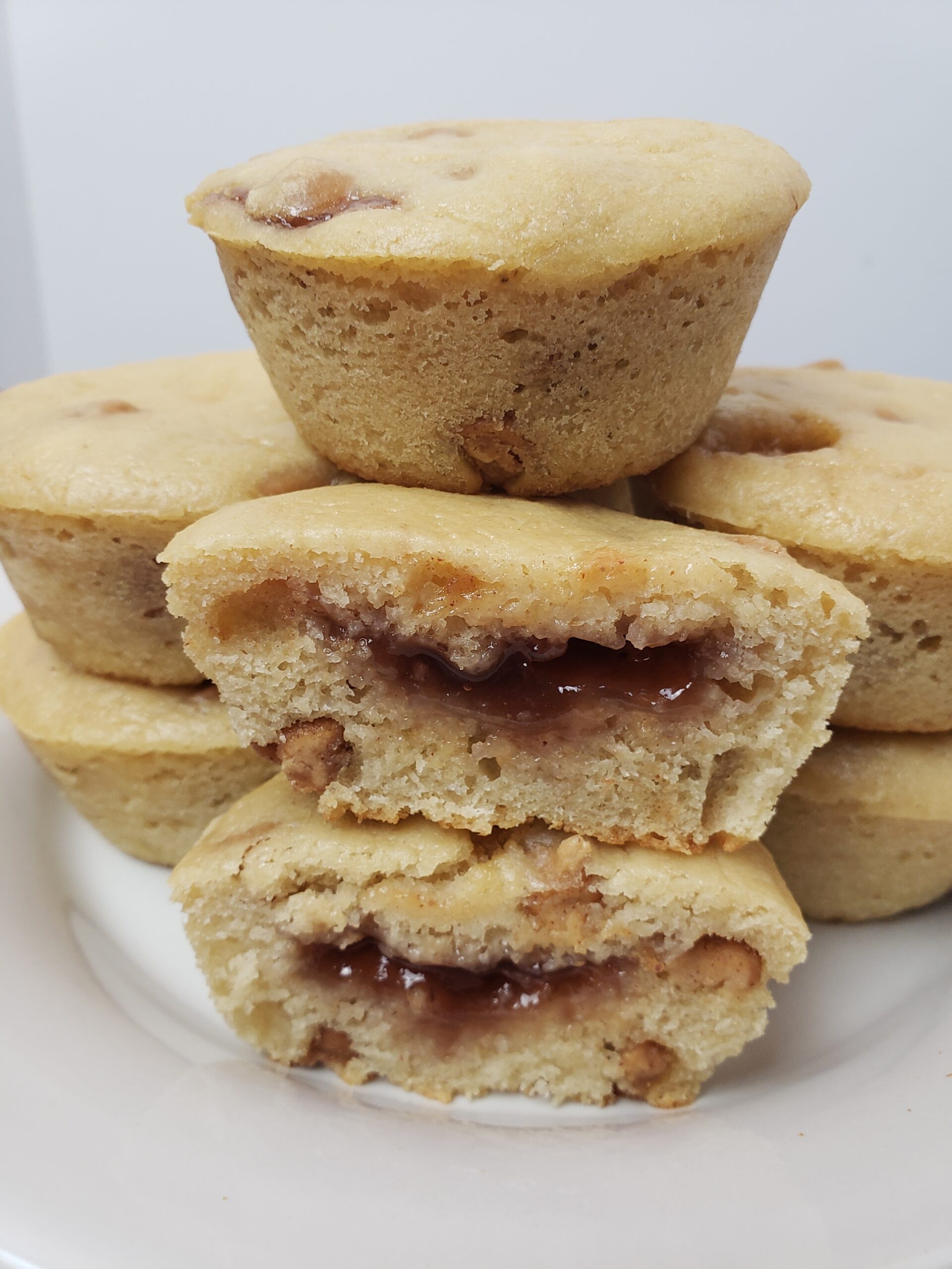 Peanut Butter Jelly Muffins piled on a plate.