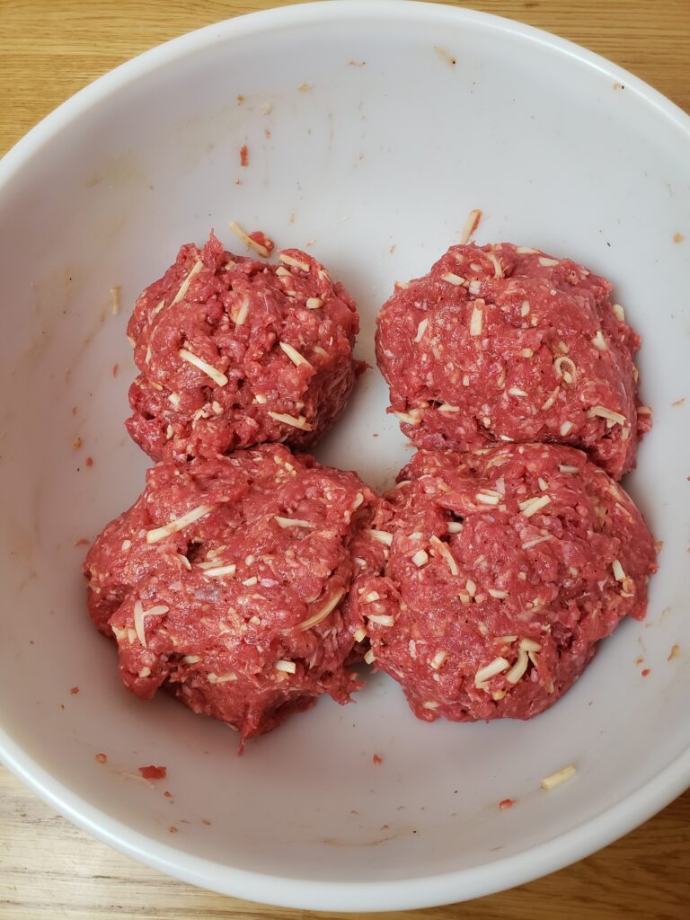 meatloaf mixture divided into four pieces