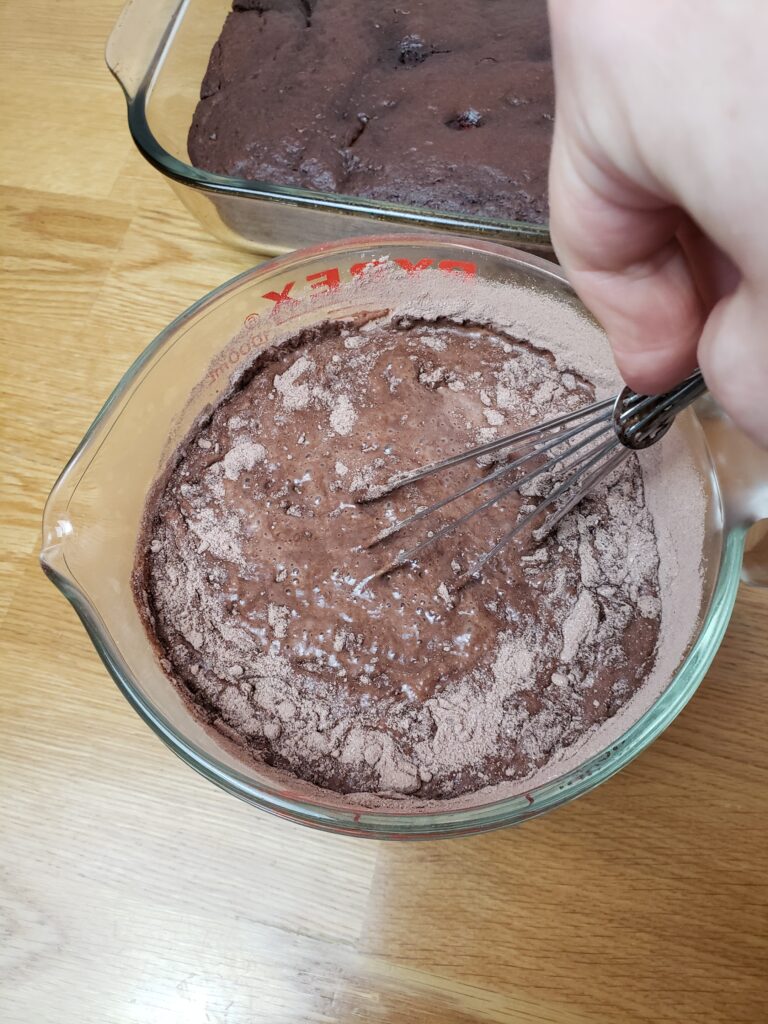 whisking milk and pudding mix in measuring cup