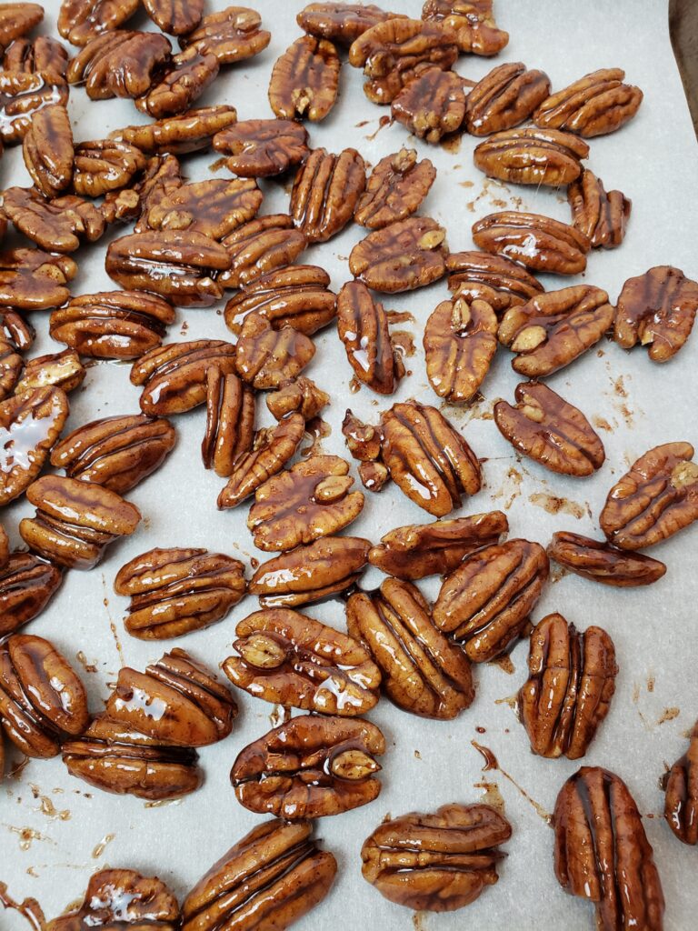 Candied Pecans cooling on parchment paper