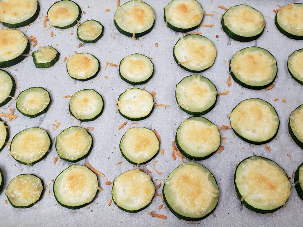 Cheesy Zucchini Coins on baking sheet after baking