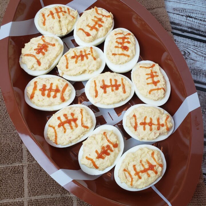 Game Day Football Deviled Eggs in football shaped serving dish