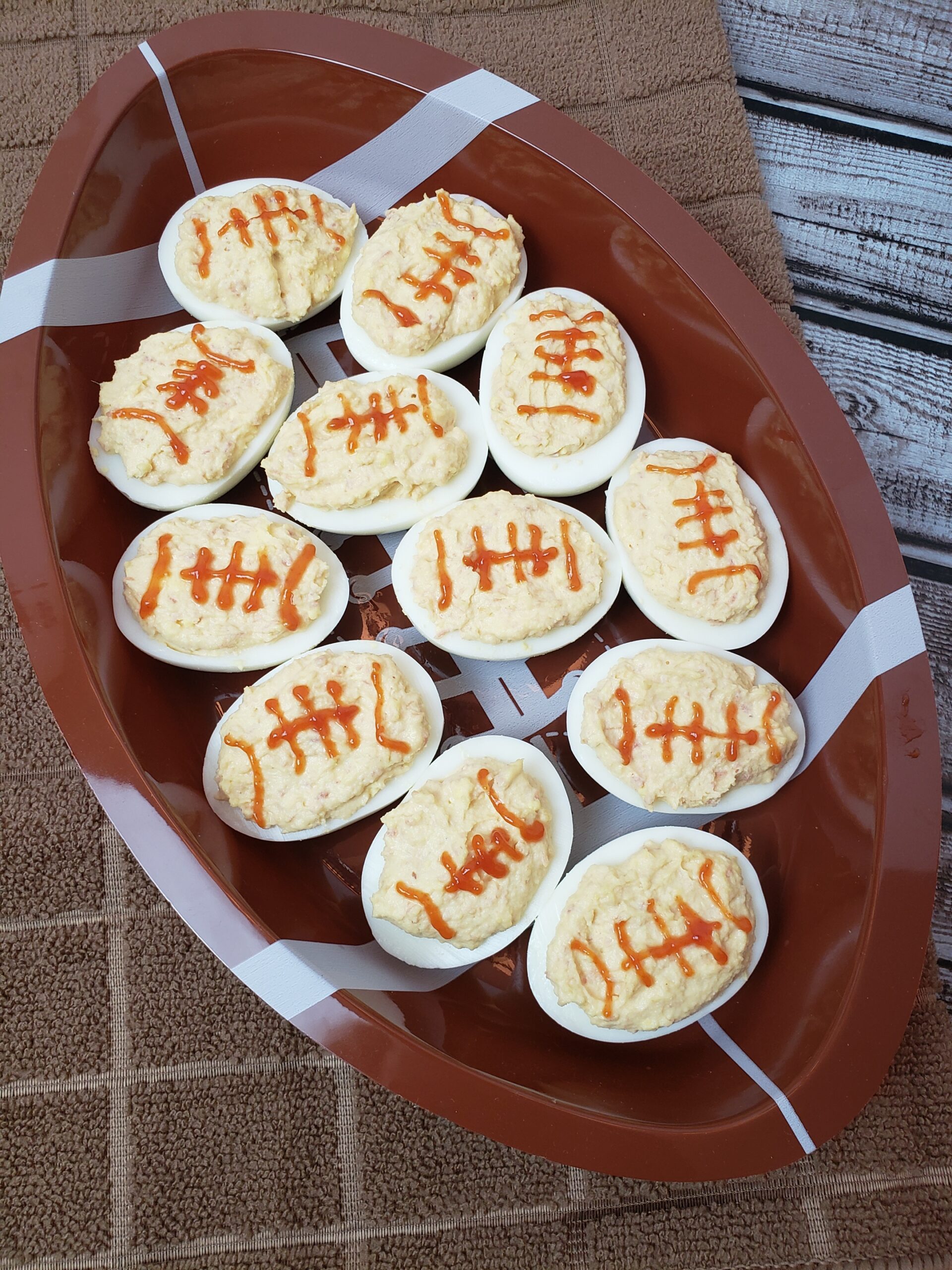 Game Day Football Deviled Eggs in football shaped serving dish