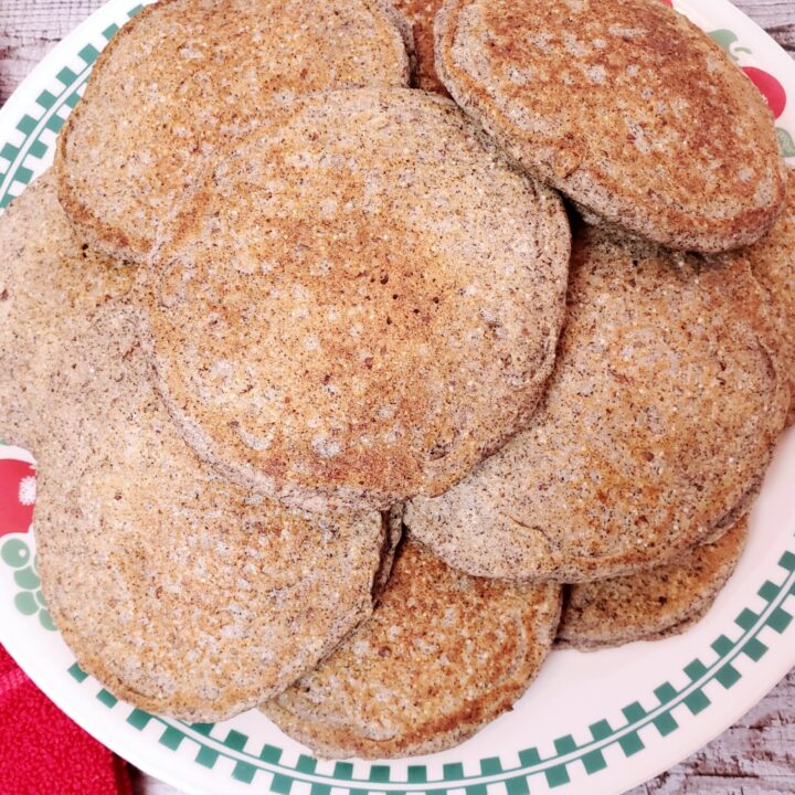 a pile of Buckwheat Almond Pancakes on a plate.