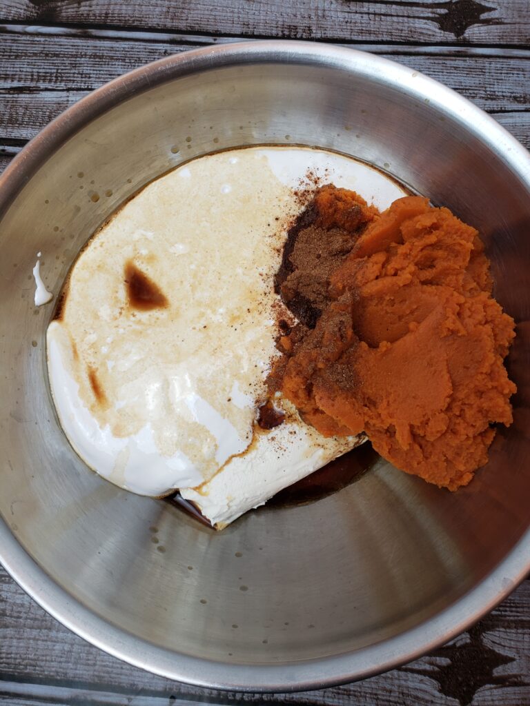 ingredients for pumpkin dip in mixing bowl.