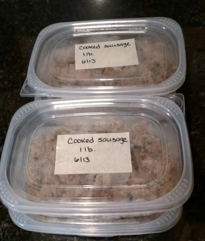 4 containers of cooked sausage ready for freezer